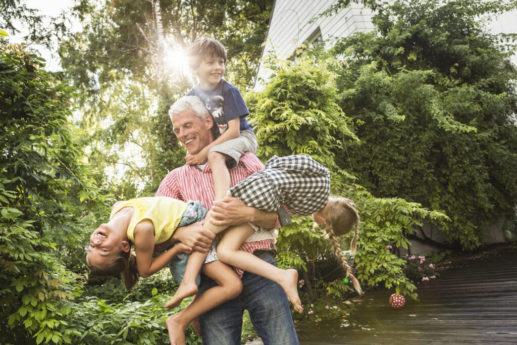 Playful outdoor family bonding activity, showcasing joyful moments of health and togetherness.