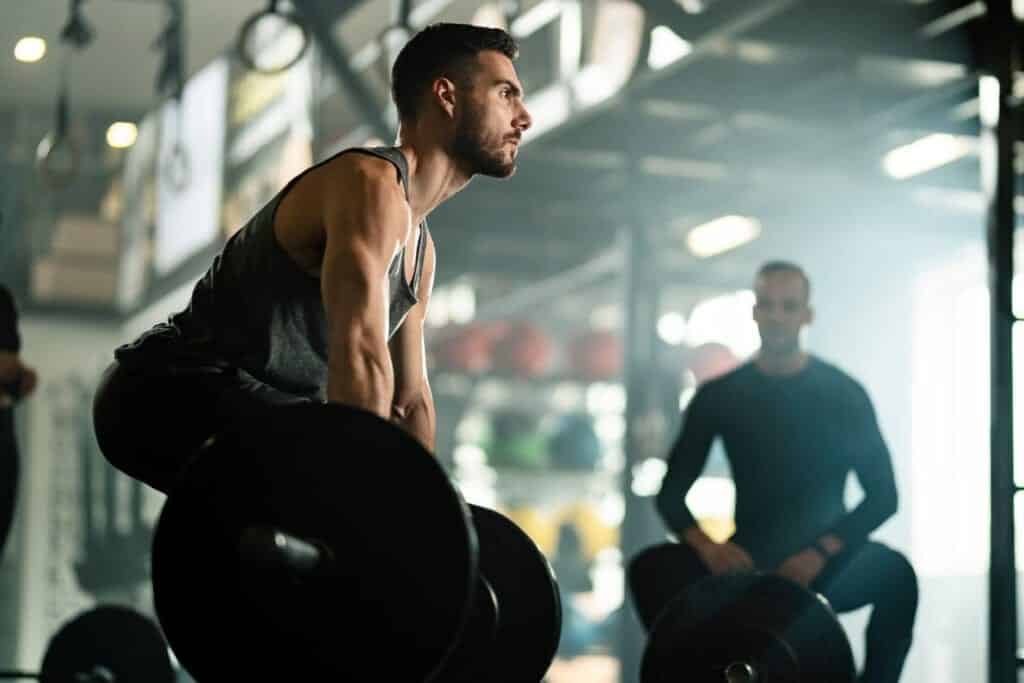 Man deadlifting heavy weights at the gym, arms jacked and with good form. He must have found natural ways to higher testosterone