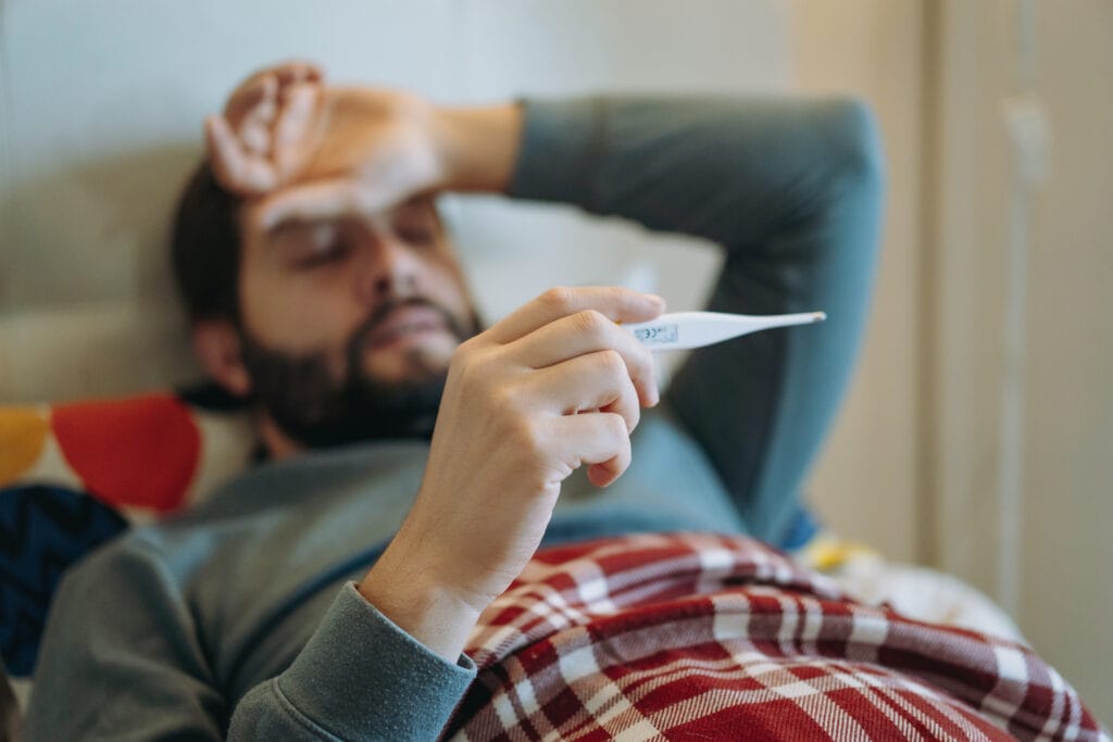 A man in bed feeling sick - could supplementing with Vitamin D3 routinely fight these colds?