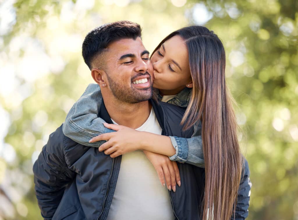 Smiling couple sharing a joyful moment outdoors, representing love, happiness, and healthy relationships due to zinc.