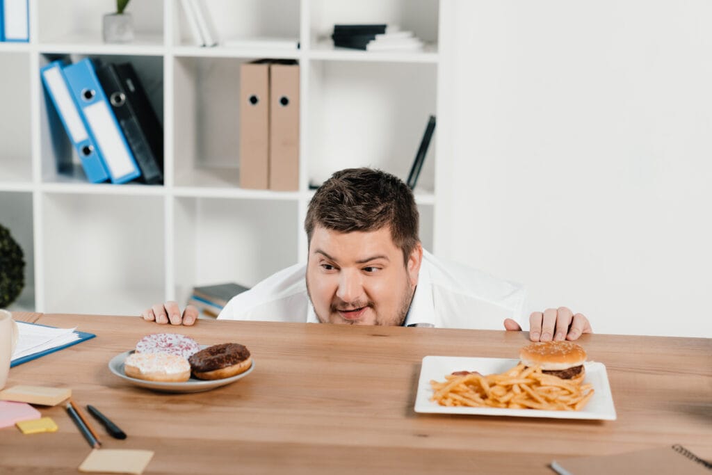 a man looking at food on a table - Can Fenugreek improve balancing sugar levels?