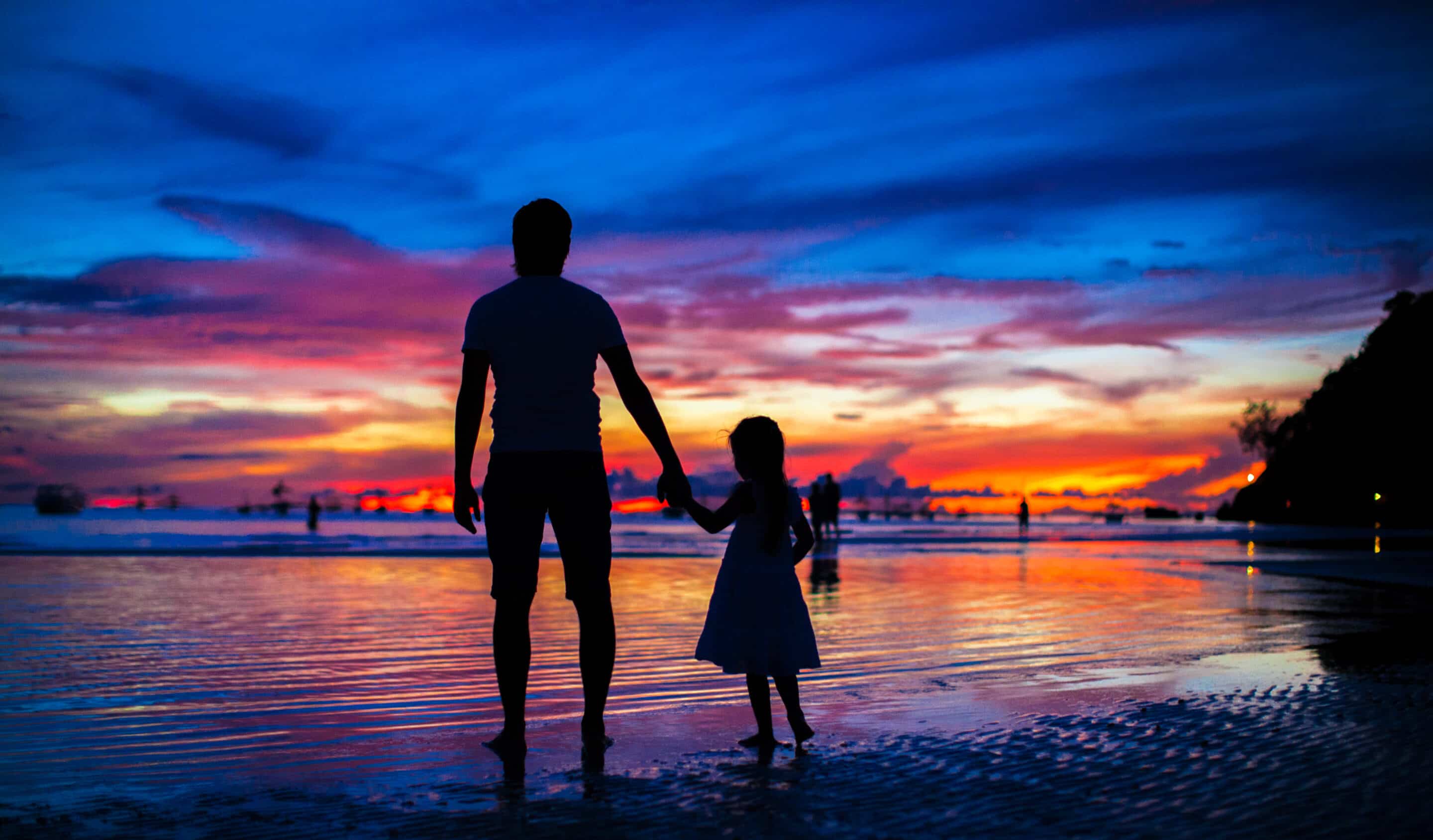 Dada and. Daughter, best friends, at beach looking at sunset. 