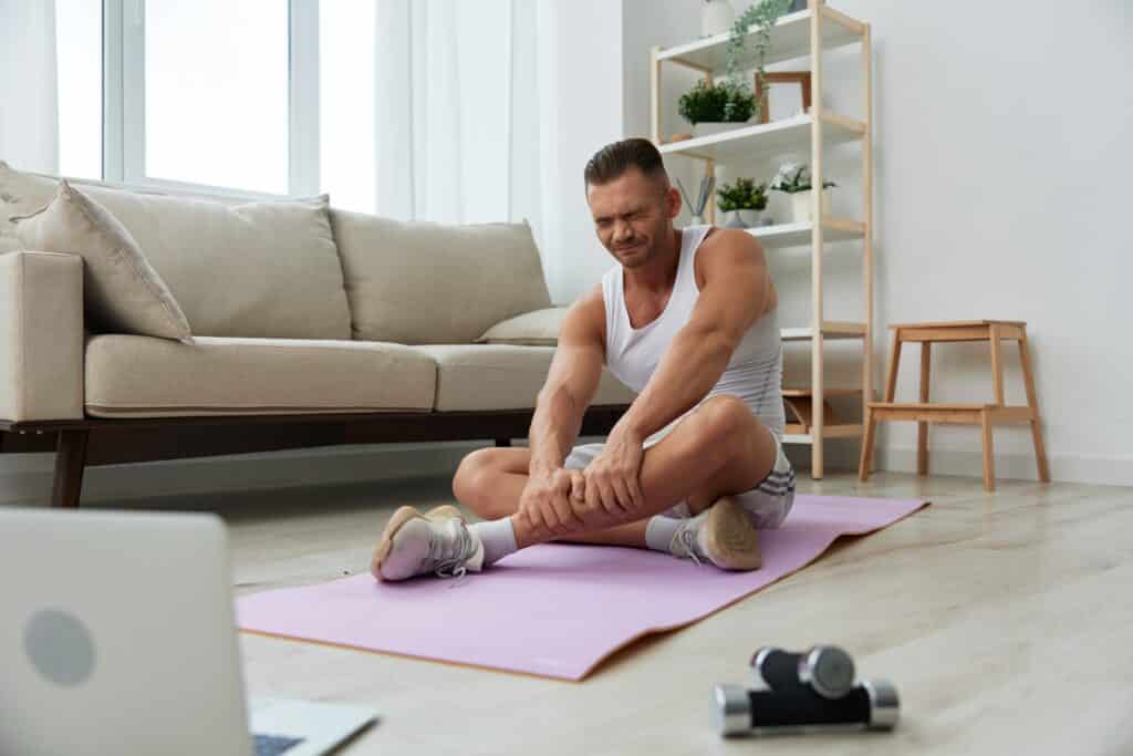 Man stretches and rubs calf due to muscle tension. Could a nightly routine of Valerian root reduce his soreness?