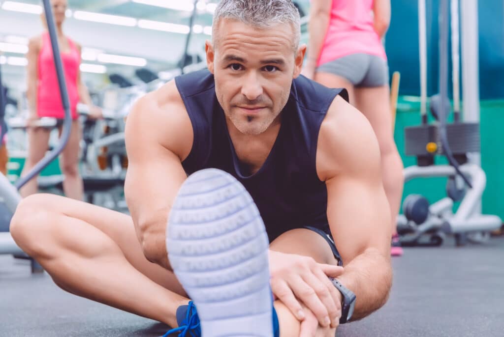 Man stretches at the gym ready to go - Fenugreek: The Best Natural Supplement for Energy